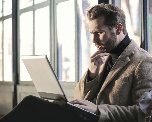 man-holding-his-chin-facing-laptop-computer.jpg man holding his chin facing laptop computer